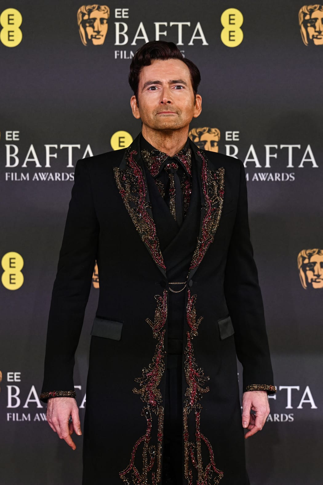 Scottish actor and presenter David Tennant poses on the red carpet upon arrival at the BAFTA British Academy Film Awards at the Royal Festival Hall, Southbank Centre, in London, on February 16, 2025.