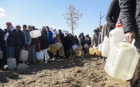 Refugees who fled the Iraqi city of Mosul due to the fighting between government forces and Islamic State, queue for heating fuel at the UN-run al-Hol refugee camp in Syria in 2017.