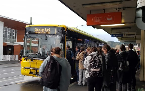 Commuters at a bus stop in Newtown