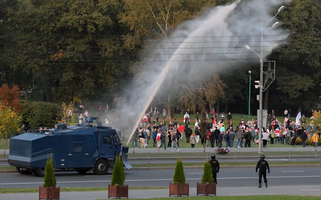 A car disperses protesters during a rally against presidential election results in Minsk, Belarus.