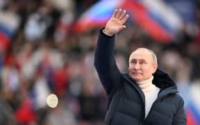 8143885 18.03.2022 Russian President Vladimir Putin waves during a concert marking the 8th anniversary of the referendum on the state status of Crimea and Sevastopol and its reunification with Russia, at Luzhniki Stadium in Moscow, Russia.