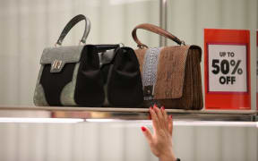 Customers look at handbags at Selfridges department store in central London, on December 26, 2016, during the post-Christmas, Boxing Day sales.