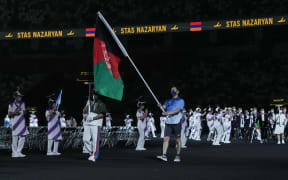 The flag of Afghanistan is carried out at the opening ceremony for the Tokyo 2020 Paralympic Games at the Olympic Stadium in Tokyo on August 24, 2021.