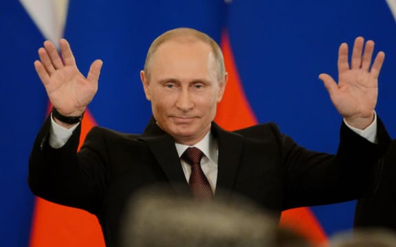 Russia's President Vladimir Putin gestures after signing a treaty on Crimea joining Russia.
