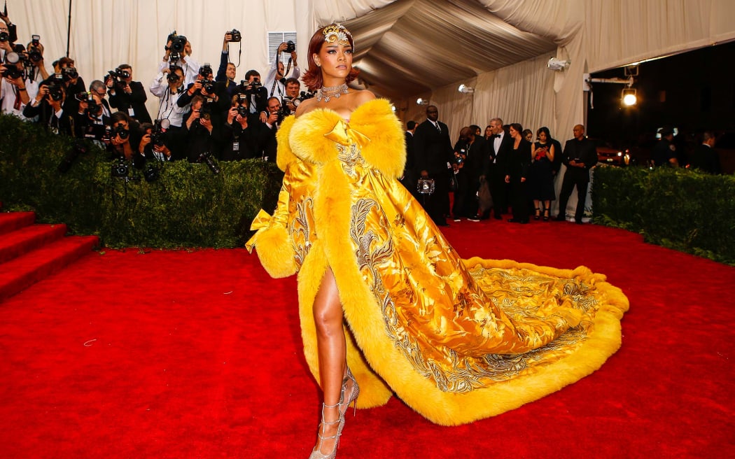 Rihanna (wearing Guo Pei) arrives at the red carpet for the 2015 Met Ball in The First Monday in May.