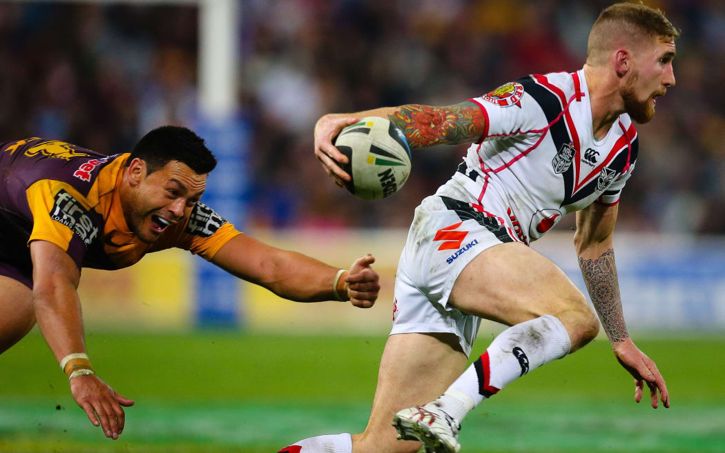 Warriors Full back Sam Tomkins evades the diving tackle of Brisbane interchange David Hala during the round 19 NRL match between the Auckland Warriors and the Brisbane Broncos at Suncorp Stadium, 2014.