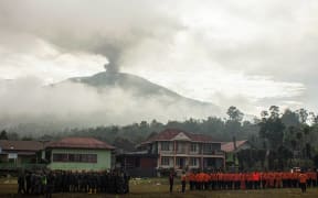 Members of an Indonesian search and rescue team gather for a roll call as they conclude the search operations on Mount Marapi after all survivors and victims have been found, in Batupalano, Agam, West Sumatra on December 7, 2023. Indonesian authorities on December 7 said they had ended a search and rescue mission for any hikers missing or killed after a volcano eruption over the weekend that left 23 people dead. (Photo by ADI PRIMA / AFP)