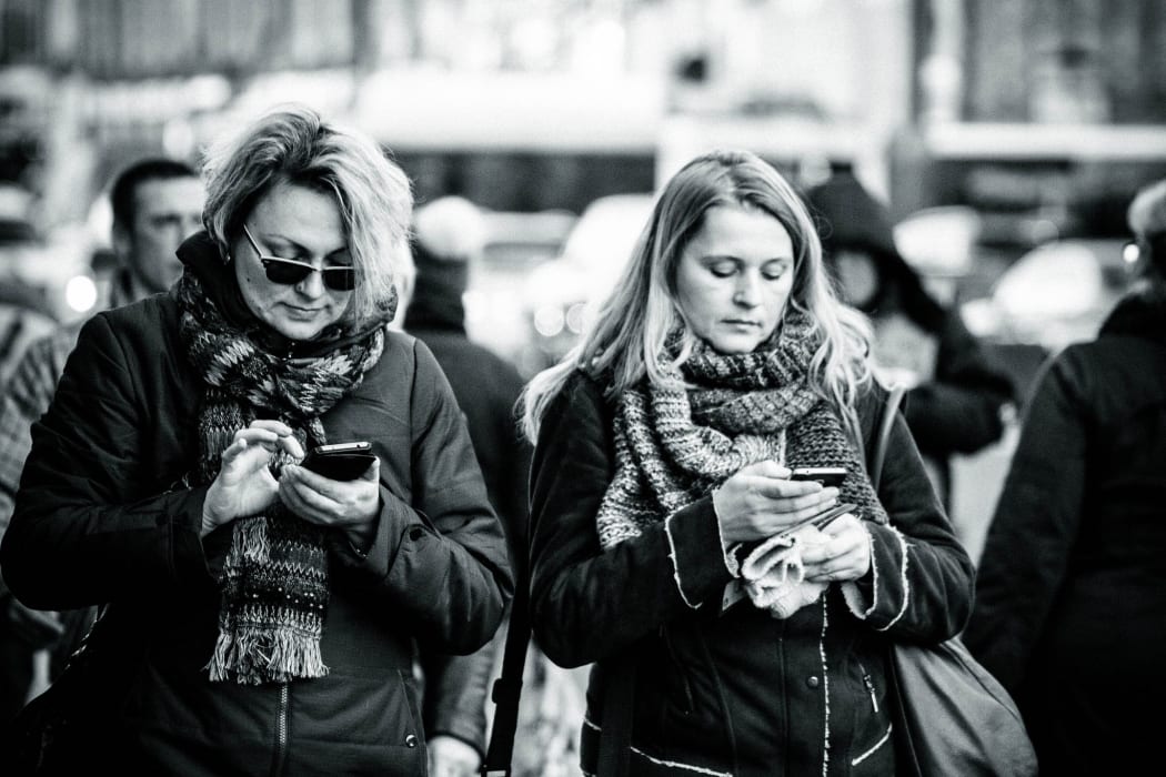 two women on phones