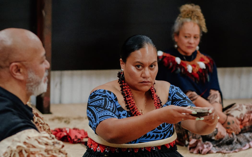 The role of Angaikava (centre) is one of service and assistance to the Taukava (left), here Malama Mahe prepares a shell of kava to be delivered by the Kau Tufa Kava.