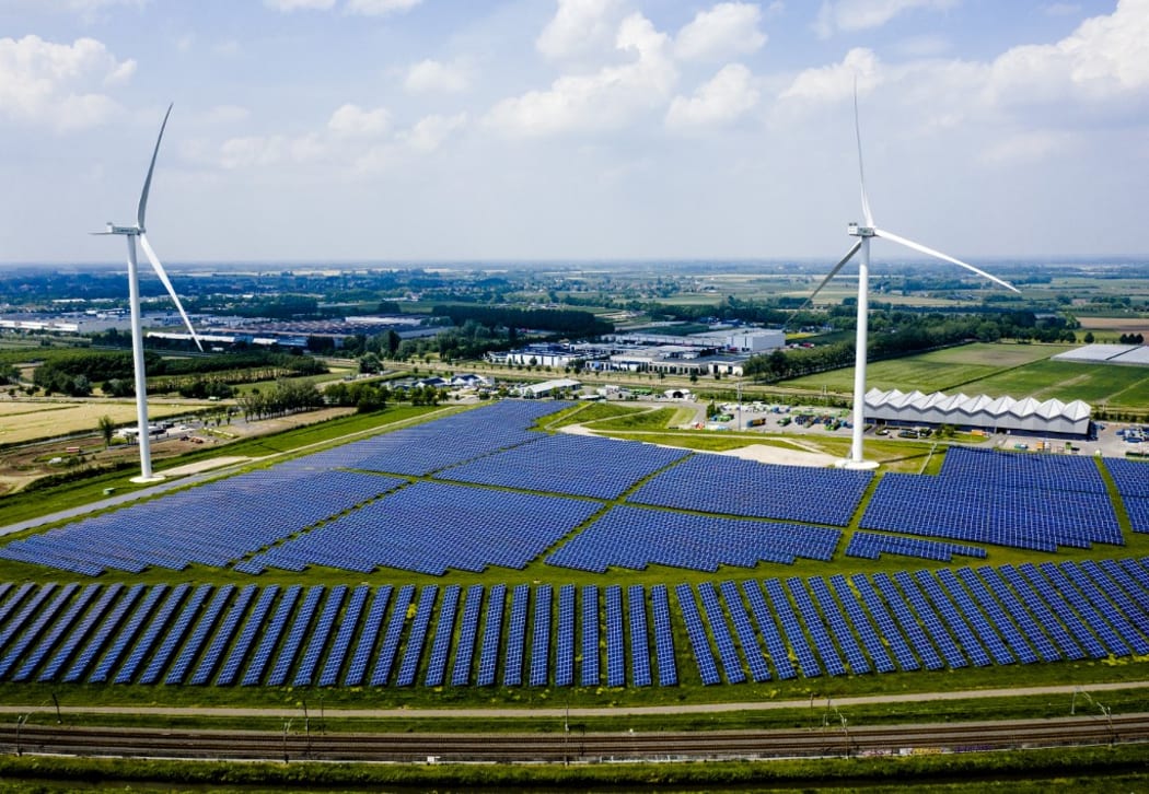 This aerial view shows the Avri solar park along the highway 'A15' in Geldermalsen, on June 4, 2021. - With 34,000 solar panels, the park is the largest in Gelderland.