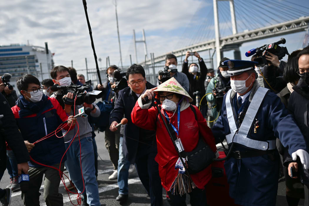 A passenger leaves after dismembarking the Diamond Princess cruise ship in quarantine at Yokohama.