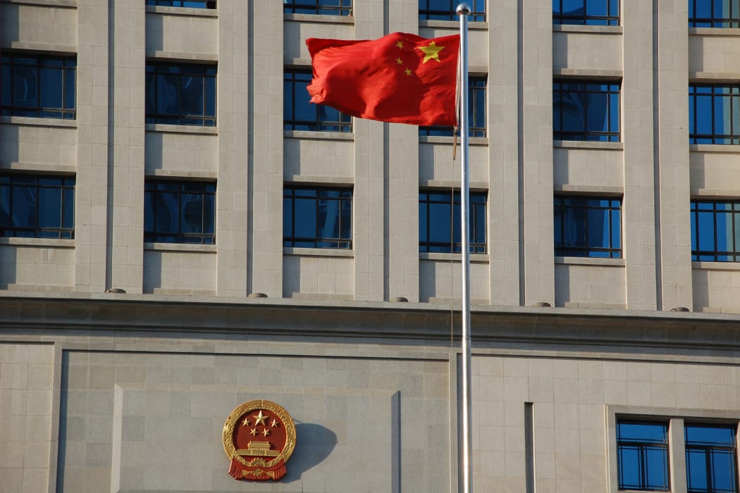 A flag flies in front of a court house in Shangdong Province, China.
