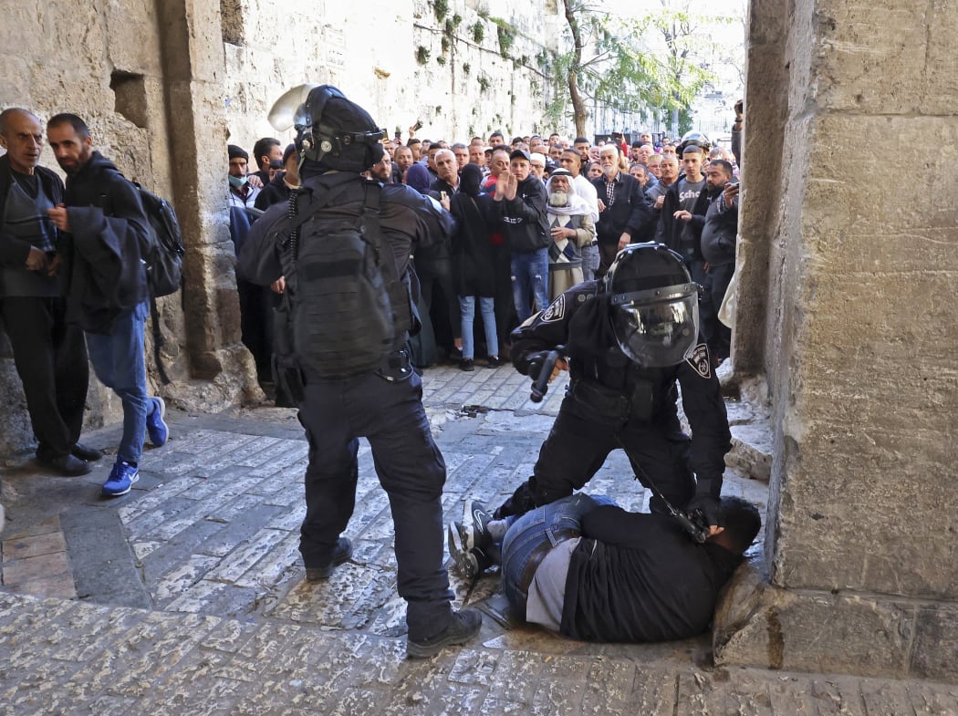 Israeli security forces immobilise a Palestinian man at an entrance to the al-Aqsa mosque  compound as others are prevented from entering, on April 15, 2022.