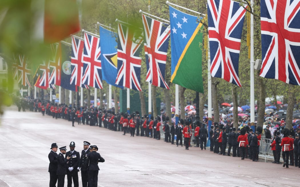 Police officers chat on The Mall in central London on May 6, 2023, after the coronations of Britain's King Charles III and Britain's Queen Camilla. - The set-piece coronation is the first in Britain in 70 years, and only the second in history to be televised. Charles will be the 40th reigning monarch to be crowned at the central London church since King William I in 1066. (Photo by ADRIAN DENNIS / POOL / AFP)