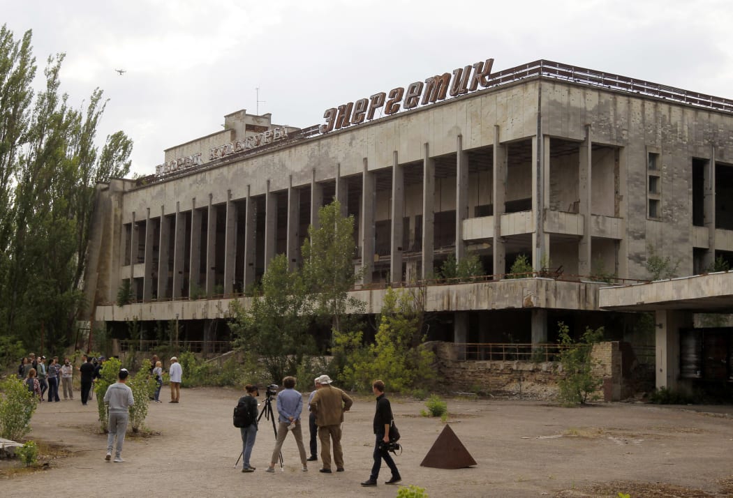 Visitors look in the abandoned city of Pripyat, near the Chernobyl nuclear power plant, Ukraine, on 7 June 2019.