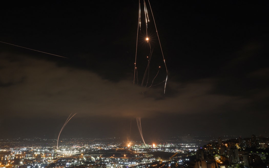 Israeli air defence systems are activated to intercept Iranian missiles over the Israeli city of Haifa.