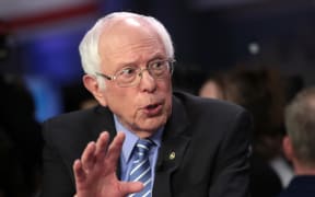 Democratic presidential candidate Bernie Sanders speaks to media in the spin room after the Democratic presidential primary debate at the Charleston on February 25, 2020.