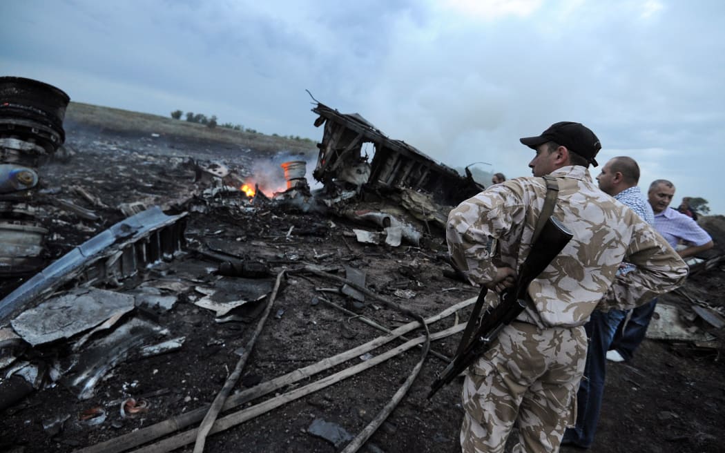 People next to the wreckage in rebel-held east Ukraine.