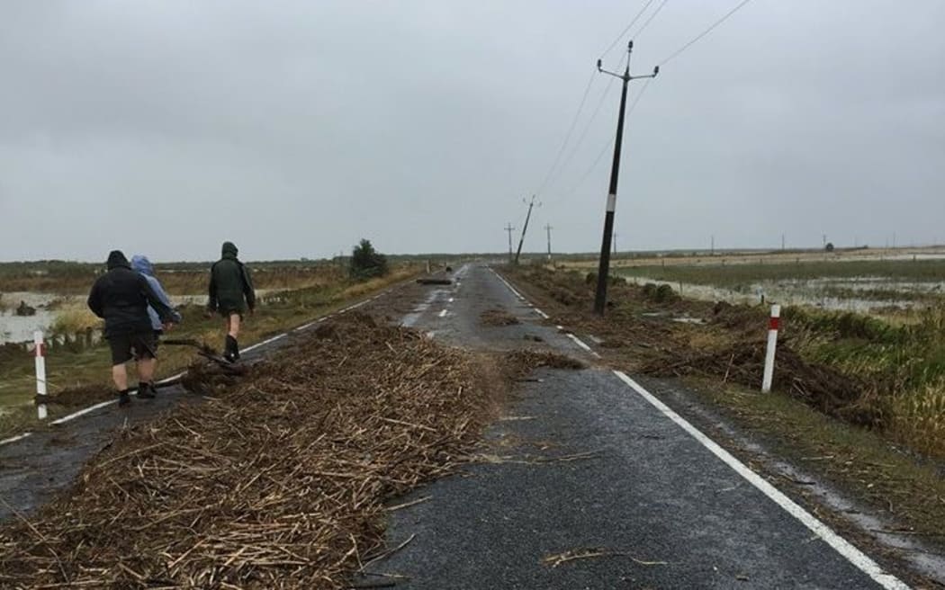 Debris cover the road in the small settlement of Kaiaua on the western side of the Firth of Thames.