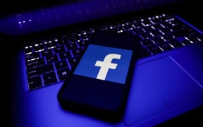 Facebook logo is seen displayed on a phone screen in this illustration photo taken in November 2020