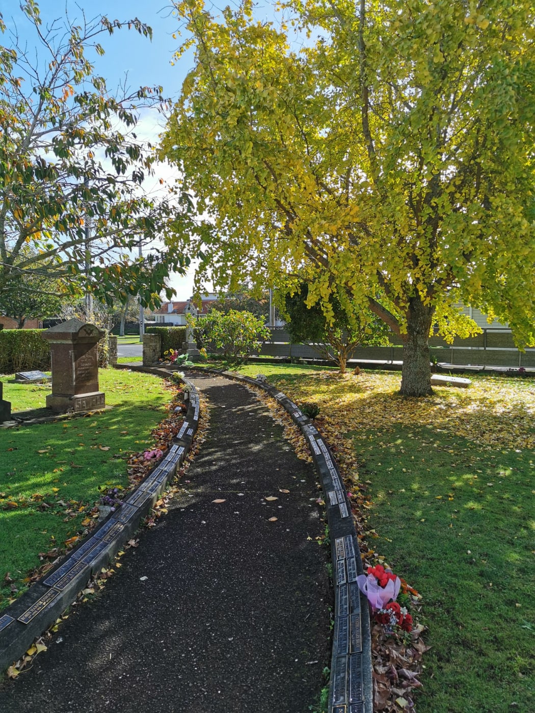 St Andrew's Cemetery. Empty spaces where plaques have been removed can be seen.