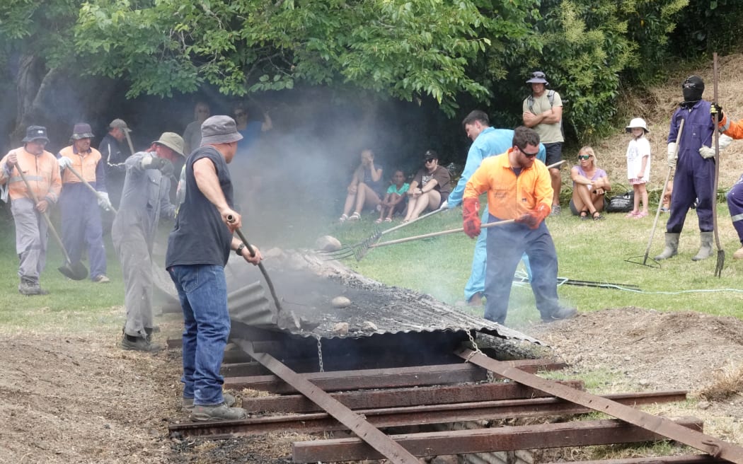 It’s hot work preparing the hāngī pit.