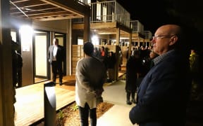Far North Holdings chief executive Andy Nock watches as the first homes at Te Kohekohe are blessed.