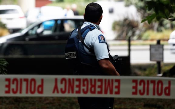A police officer secures the area in front of the Masjid al Noor mosque.