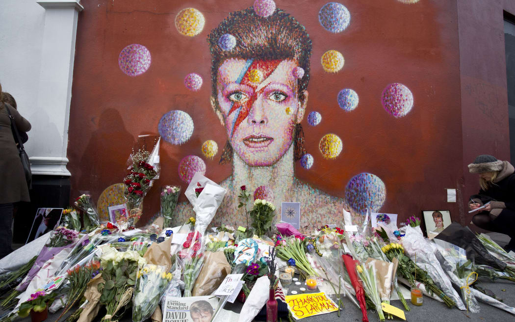 Floral tributes are left beneath a mural of David Bowie painted by Australian street artist James Cochran, aka Jimmy C, in Brixton, South London.