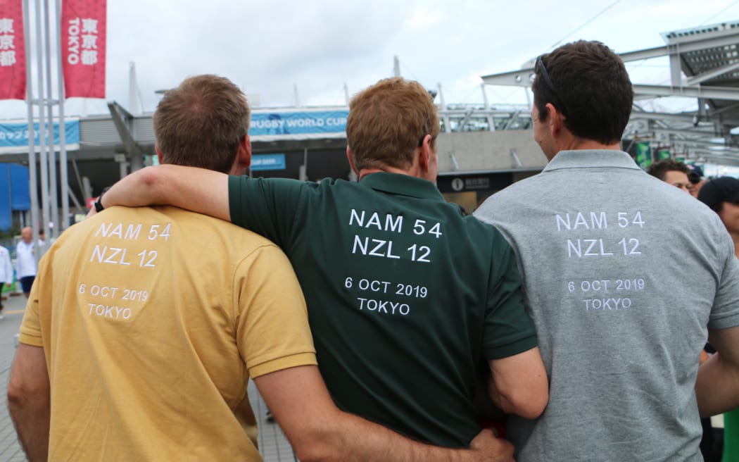 Mark Reinecke and friends, who wore custom shirt to the New Zealand v Namibia game, with their own wishful outcome.