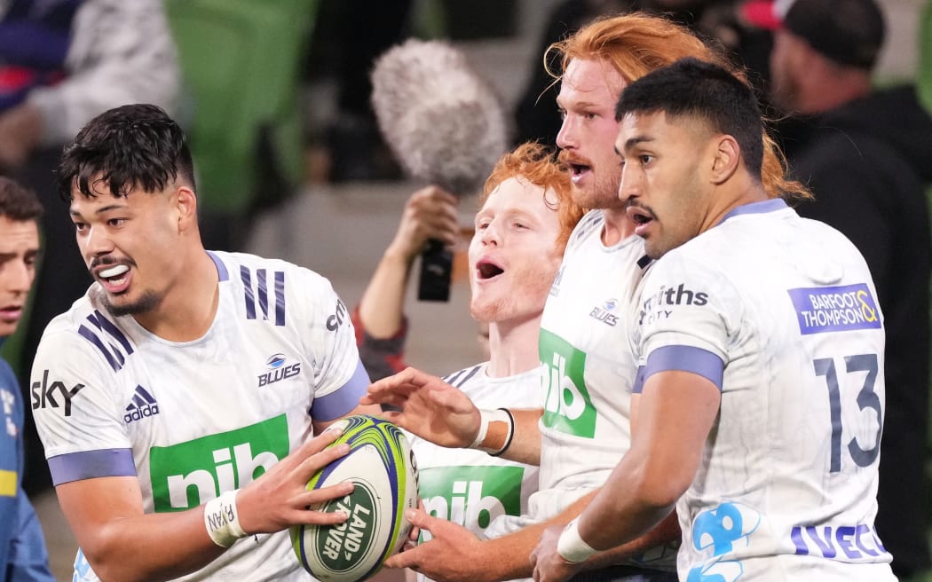 Tom Robinson of the Blues is congratulated by his teammates after scoring a try during the Round 1 Trans-Tasman Super Rugby match between the Melbourne Rebels and the Auckland Blues at AAMI Park in Melbourne, Saturday, May 15, 2021. (AAP Image/Scott Barbour) NO ARCHIVING, EDITORIAL USE ONLY