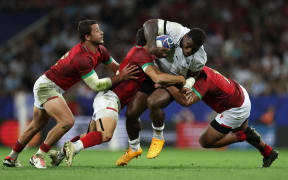 Fiji's inside centre Josua Tuisova (centre) is tackled by Portugal's inside centre Jose Lima (left) Portugal's wing Raffaele Storti (second left) and Portugal's hooker David Costa (right) during the France 2023 Rugby World Cup Pool C match between Fiji and Portugal at the Stade de Toulouse in Toulouse, southwestern France on October 8, 2023.
