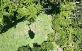 Carolyn Lloyd used rocks and sticks to write 'help', which was spotted by a helicopter crew searching for the missing mother and daughter.