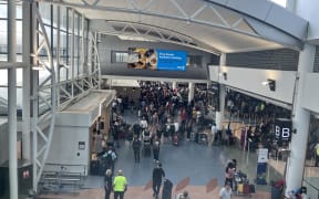 Crowds at Auckland Airport as travelers head away for Christmas 2024.