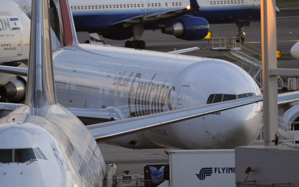 Emirates Airlines flight 201 (middle-R) is seen at New York's John F. Kennedy International Airport on October 29, 2010. The flight which originated in Yemen was reportedly escorted by US fighter jets as it reached US air space because it had a package from Yemen on board.