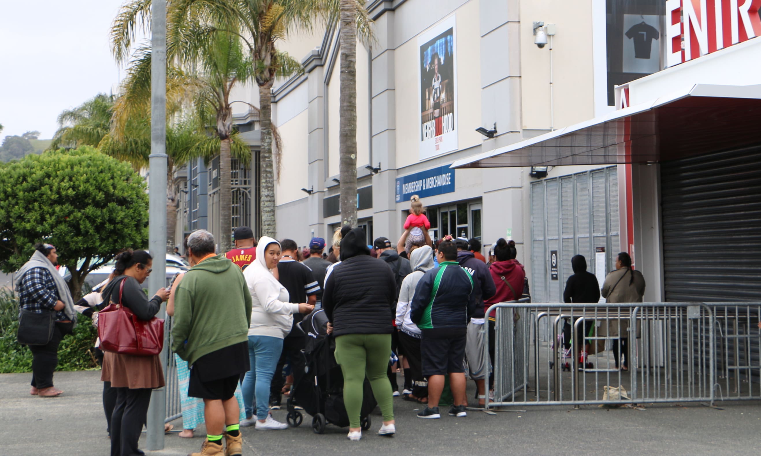 People line up outside Eden Park to collect food and Christmas gifts from Auckland City Mission.
