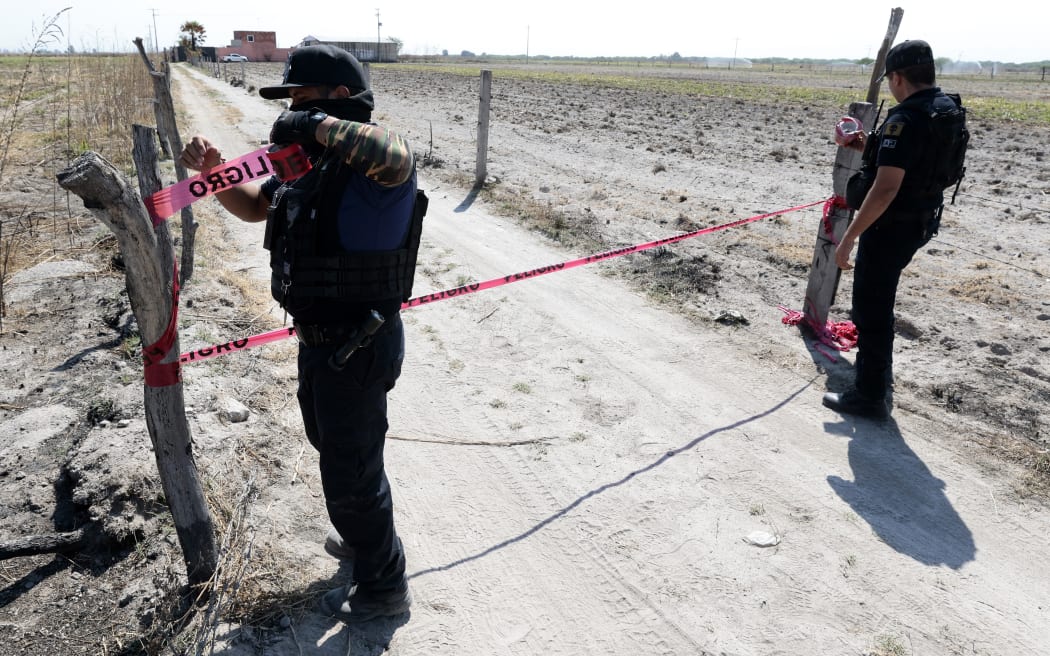Police cordon off the entrance to a ranch in the community of La Estanzuela,  where the collective Guerreros Buscadores - the Warrior Searchers, found three human crematoriums while searching for their relatives in Jalisco state, Mexico, on 10 March, 2025.