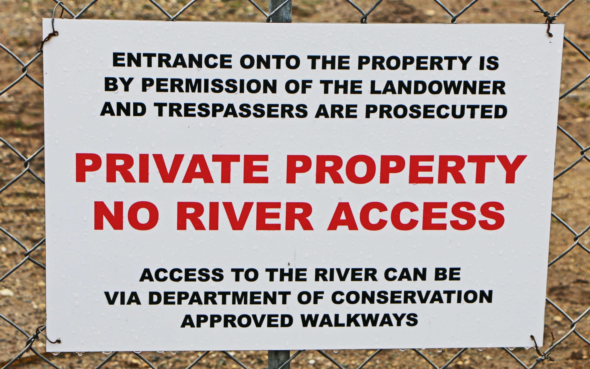 Sign saying Private Property entrance by permission, trespassers prosecuted.