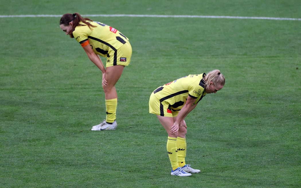 Phoenix pair Mackenzie Barry (L) with Betsy Hassett stand dejected after their women's A-League loss to Melbourne City FC.