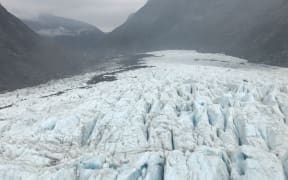 Ice at Fox Glacier seen with some yellowy ash patches on 1 January, 2020, after smoke from Australia's ongoing bushfires drifted across the Tasman.