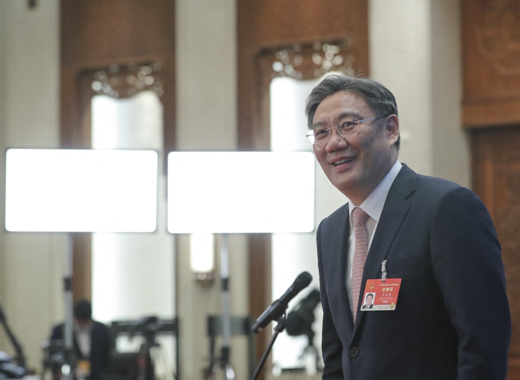 Chinese Minister of Commerce Wang Wentao prepares to leave after giving an interview via video link following the second plenary meeting of the fourth session of the 13th National People's Congress (NPC) in Beijing, capital of China, March 8, 2021.