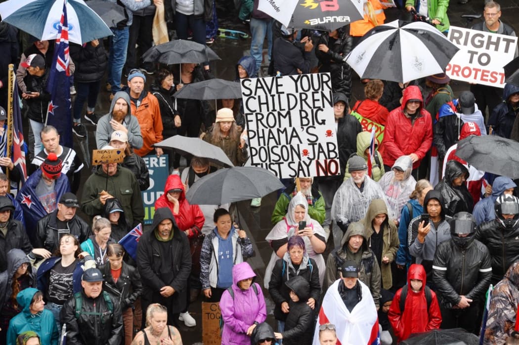 Members of the Freedom and Rights Coalition take part in a protest outside the police station in Christchurch, New Zealand