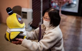 A diner holding a Lovot robot in a cafe in Kawasaki on 20 December 2020.