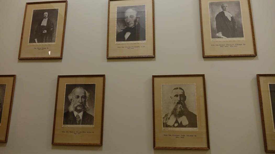 Most of the framed photos on the walls of Parliament show white, middle-aged men.