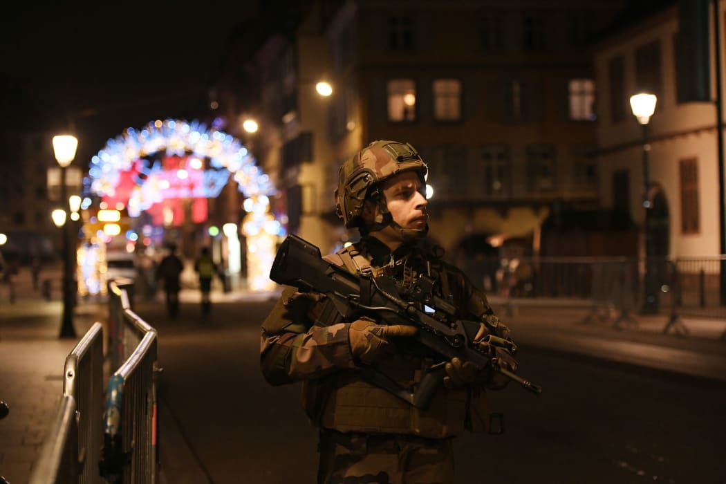 A military stands in the streets of Strasbourg, eastern France, after a shooting breakout.