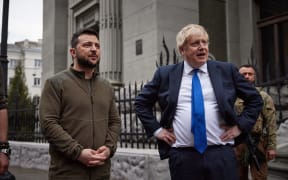 British Prime Minister Boris Johnson (R) and Ukrainian President Volodymyr Zelensky (L) speaking after walking in central Kyiv, on 9  April 2022.