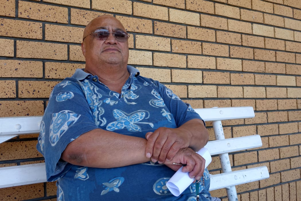 Man on a bench in island shirt
