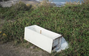 Dumped refrigerator and view of chalk cliffs between Folkestone and Dover, UK. (Photo by ROBERT BROOK/SCIENCE PHOTO LIBRA / RBR / Science Photo Library via AFP)