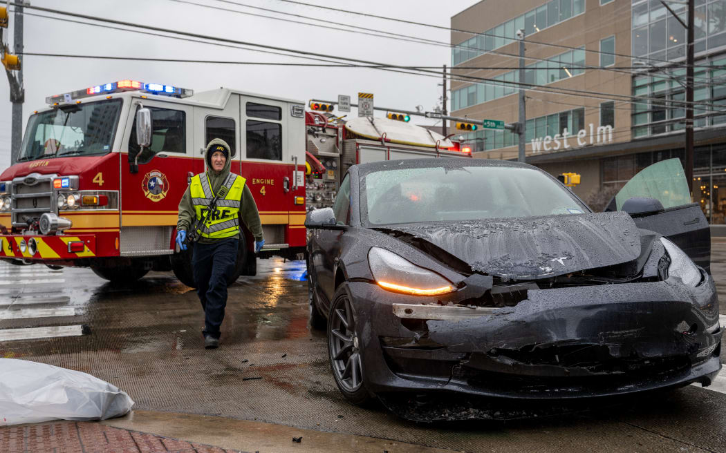 A first responder attends to a collision on February 01, 2023 in Austin, Texas. A winter storm is sweeping across portions of Texas, causing massive power outages and disruptions of highways and roads.