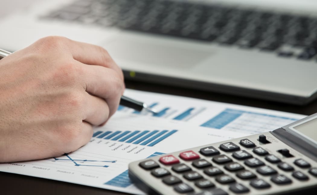 Businessman analyzing investment charts with laptop